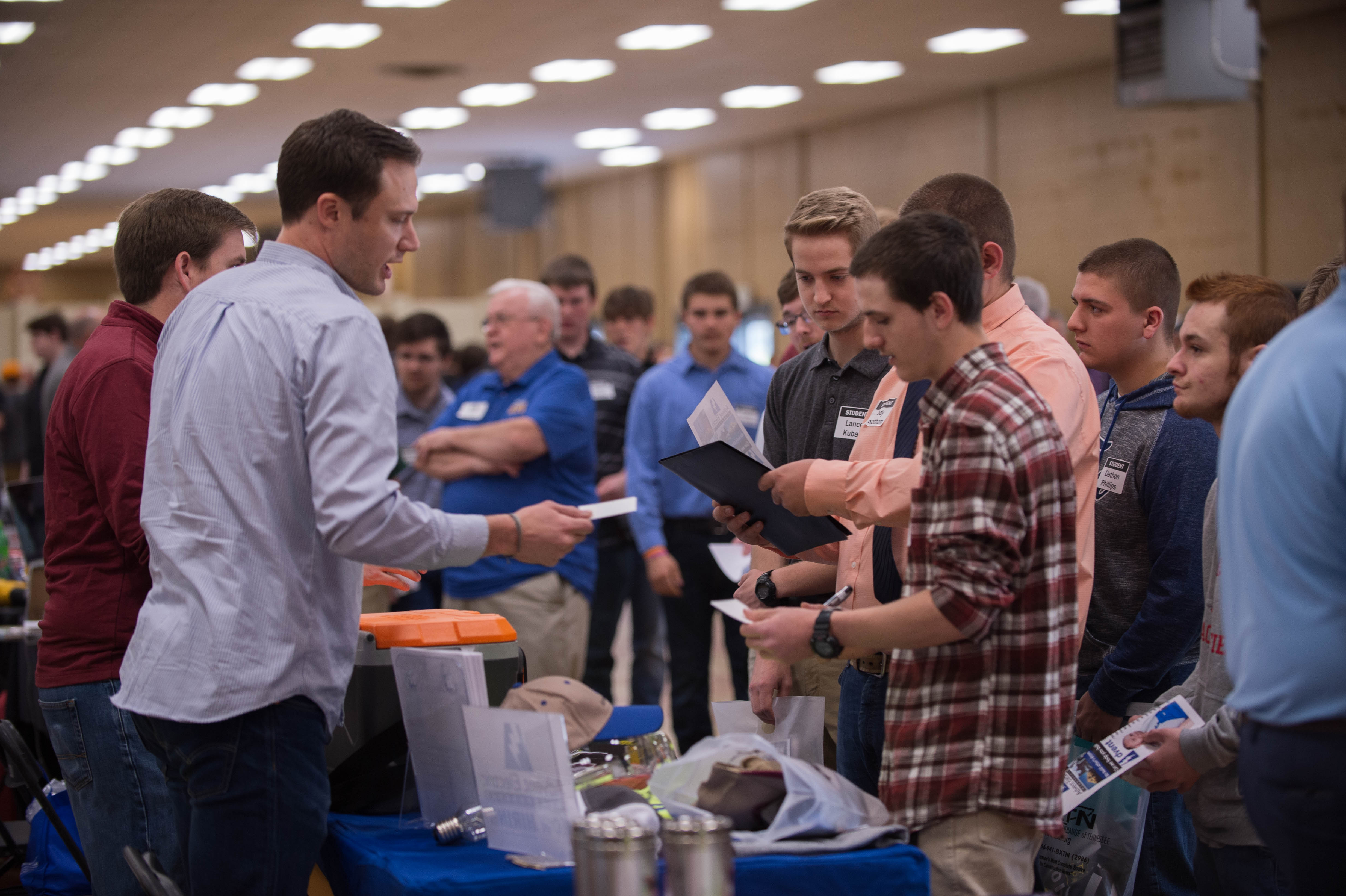 Photo of Students Gathered Around a Booth at the CTEP Career Fair